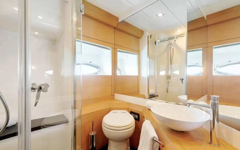 a bathroom with a glass shower aboard WAHOO Yacht for Sale