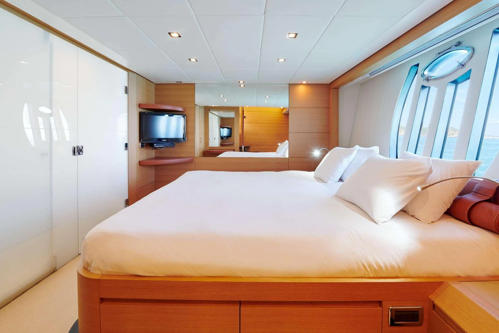 a bed with white sheets aboard WAHOO Yacht for Sale