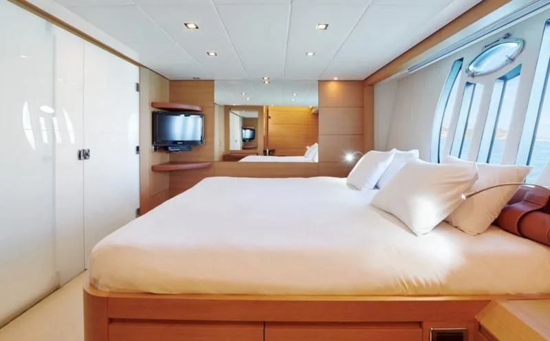 a bed with white sheets aboard WAHOO Yacht for Sale