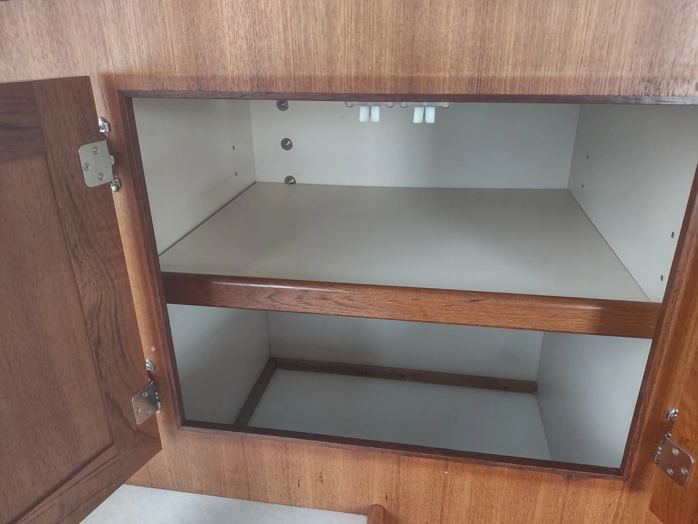 a wooden cabinet with a light switch aboard UNWINED Yacht for Charter
