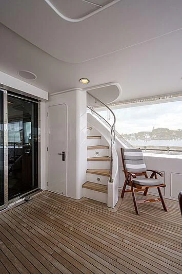 a room with a chair and a ladder aboard UNWINED Yacht for Charter