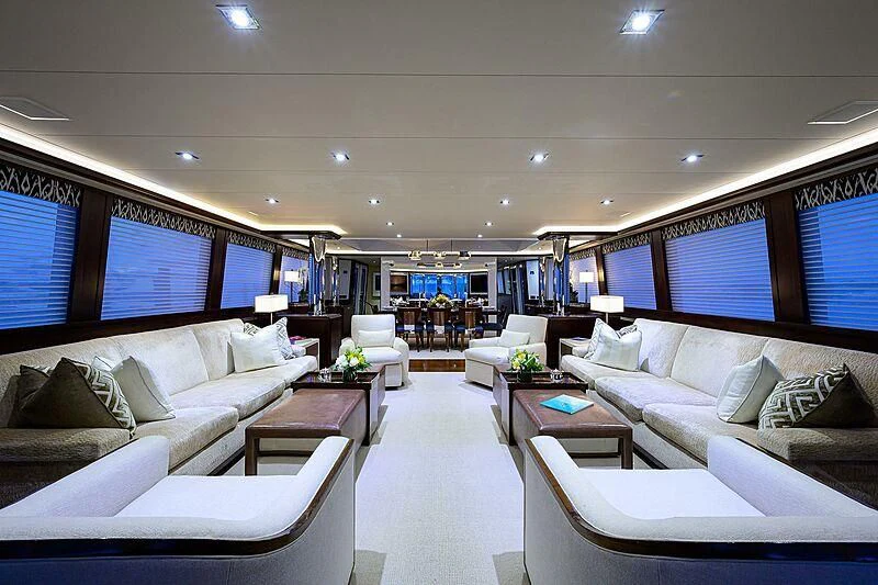 a room with white couches and a table aboard UNWINED Yacht for Charter