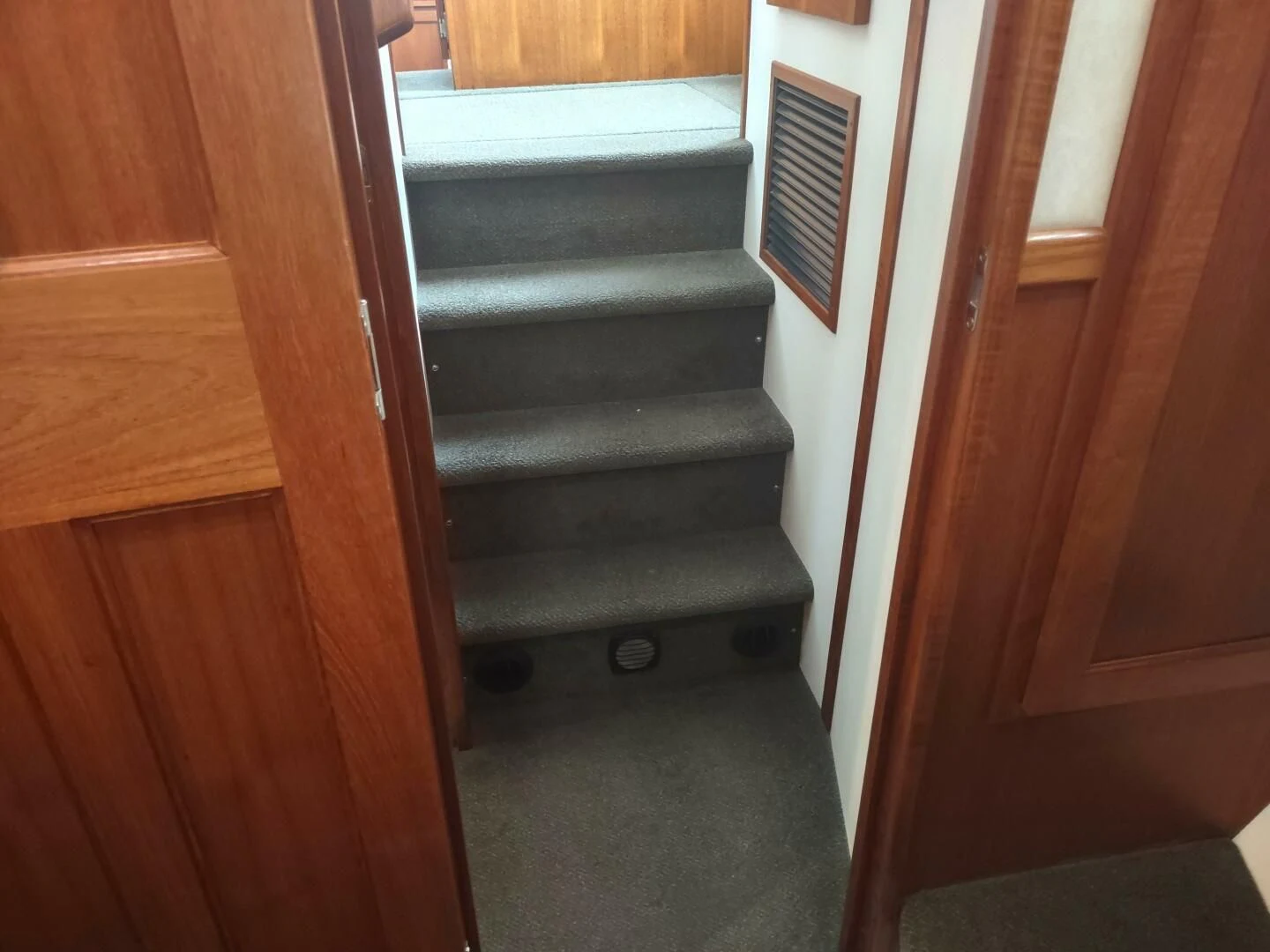 a wooden staircase with a metal railing aboard UNWINED Yacht for Charter
