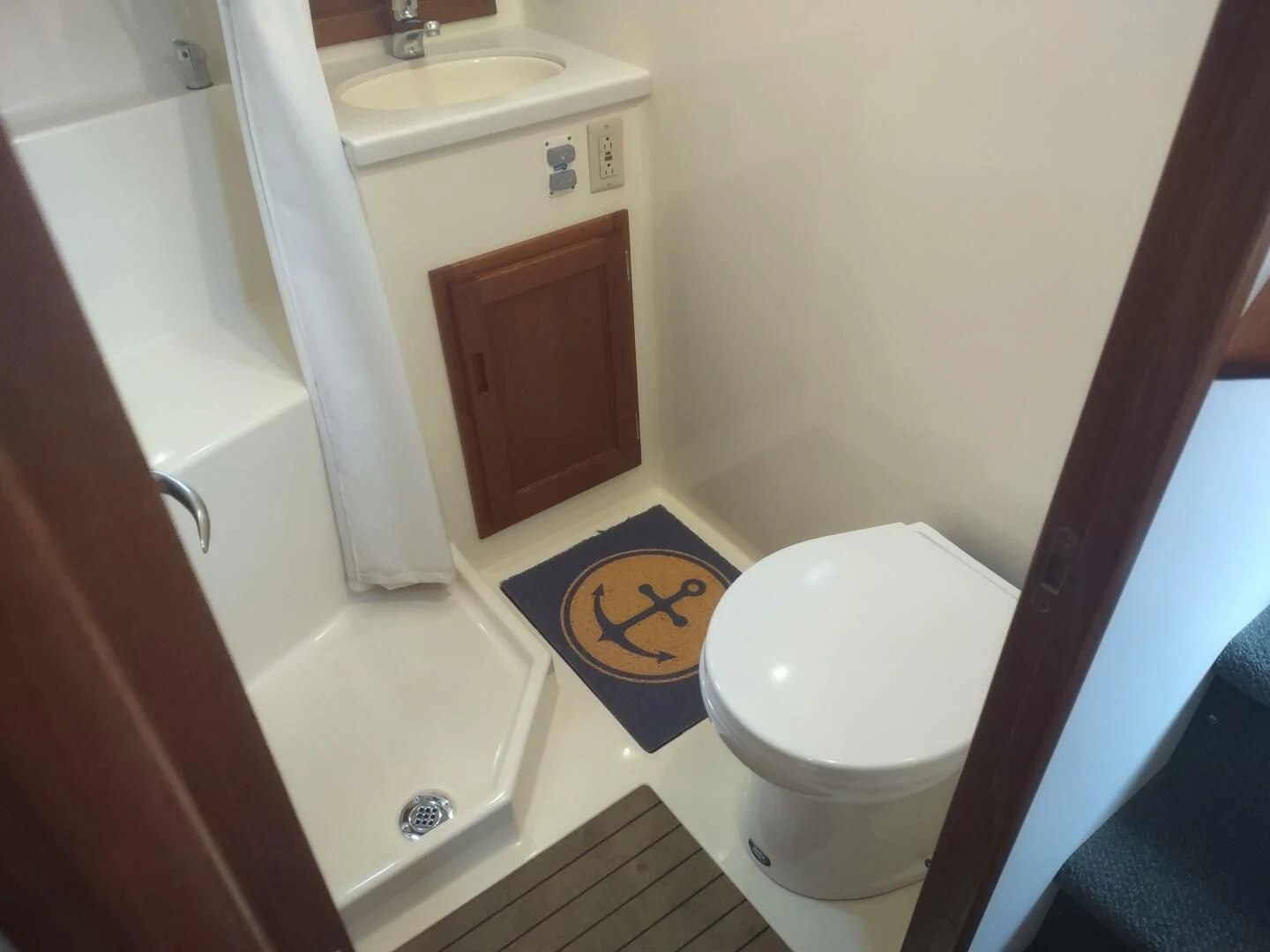 a bathroom with a toilet and sink aboard UNWINED Yacht for Charter