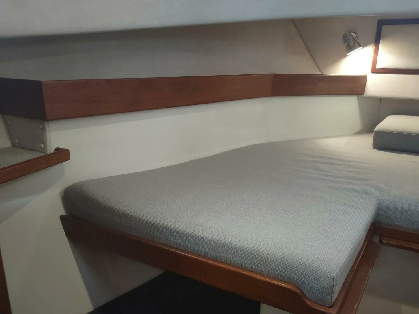 a bed with a white sheet aboard UNWINED Yacht for Charter