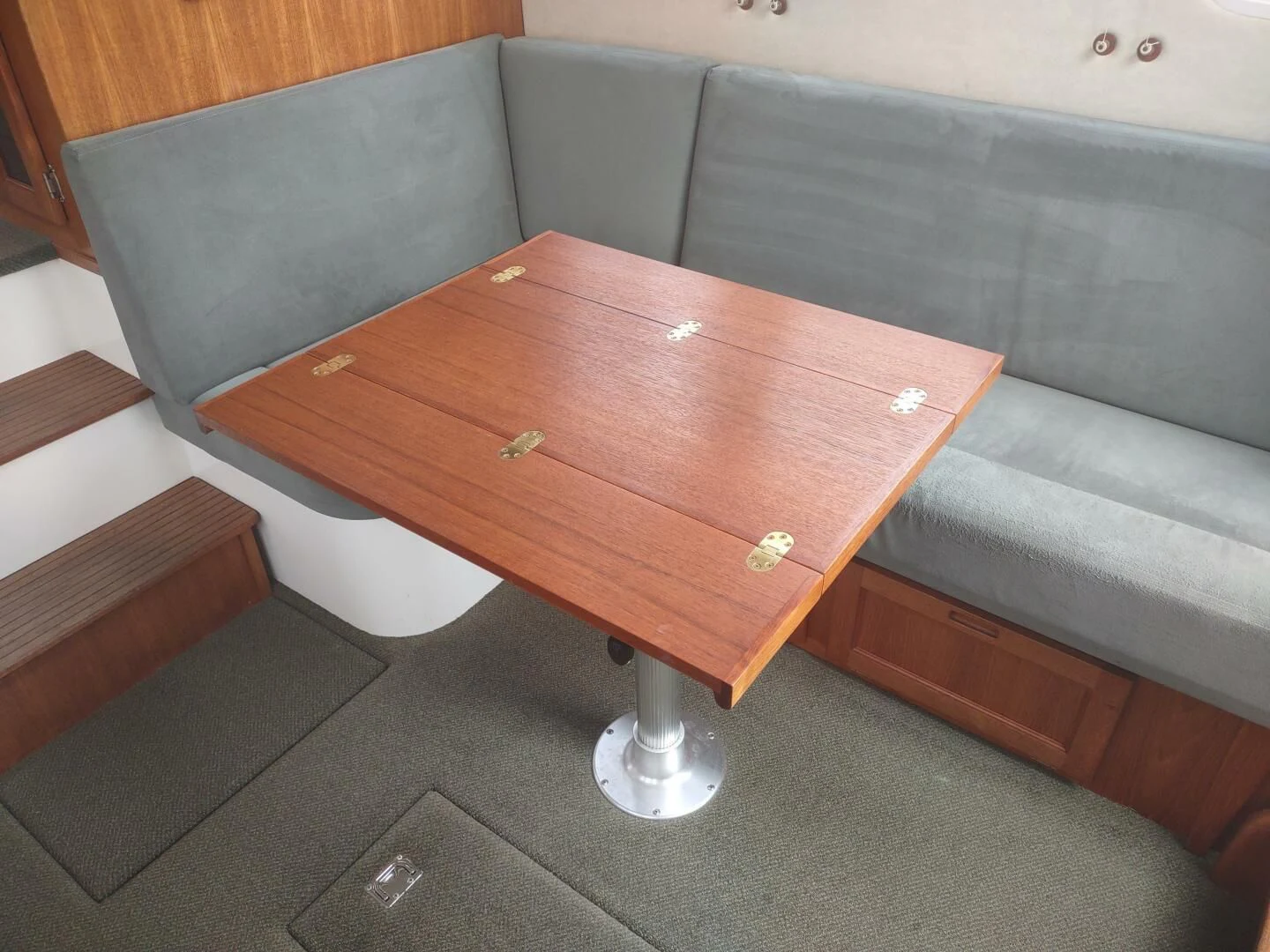 a wooden coffee table aboard UNWINED Yacht for Charter