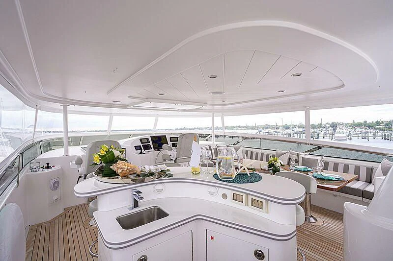 a large white kitchen with a large white table and chairs aboard UNWINED Yacht for Charter