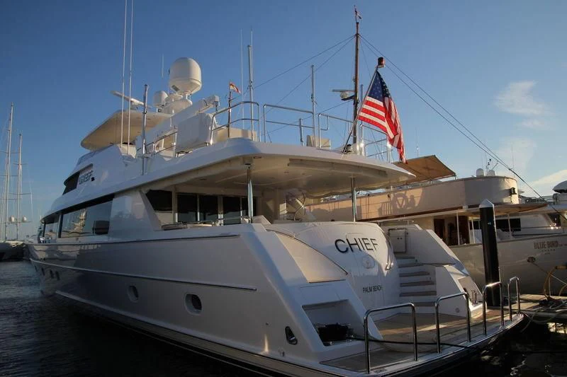 a large boat with a flag on the front aboard UNWINED Yacht for Charter