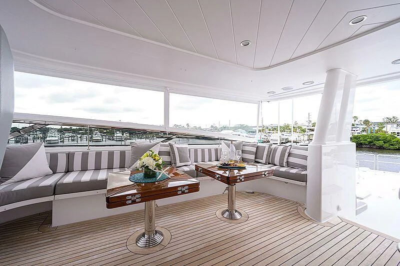 a living room with a large white column and a table with a white pillar and a white pillar aboard UNWINED Yacht for Charter