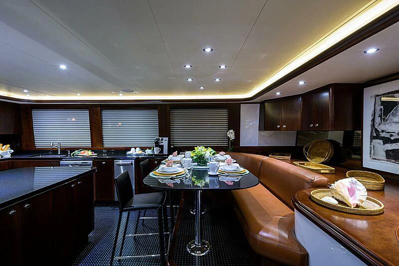 a kitchen with a table and chairs aboard UNWINED Yacht for Charter