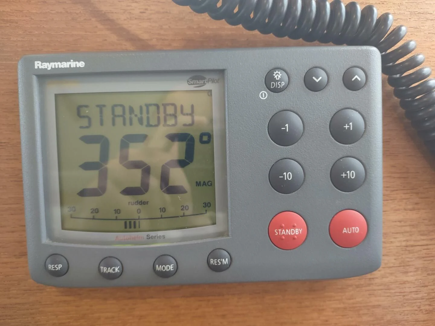 a digital clock on a wooden surface aboard UNWINED Yacht for Charter