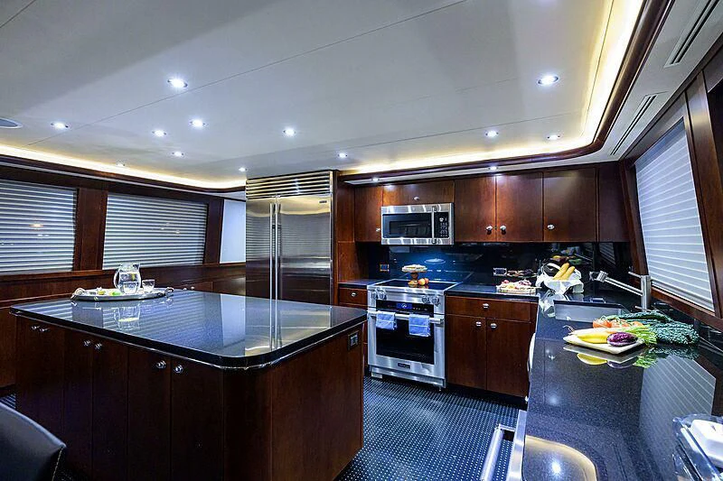 a kitchen with black counter tops aboard UNWINED Yacht for Charter