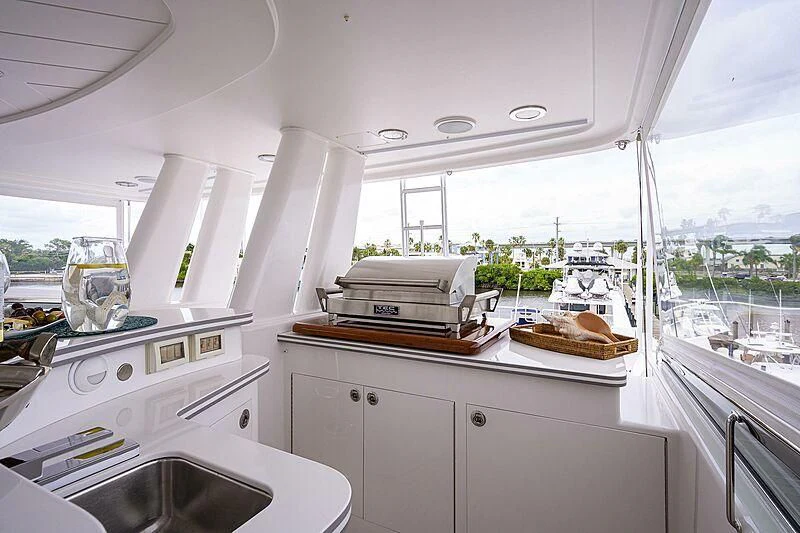 a kitchen with a sink and a large window aboard UNWINED Yacht for Charter