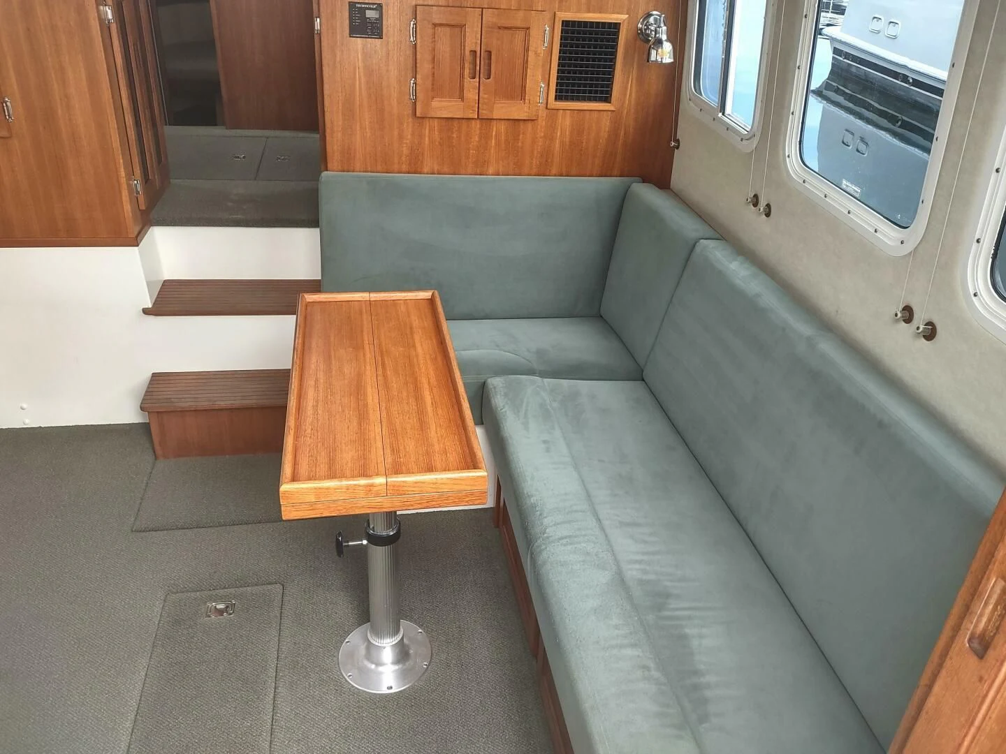a couch and a table in a room aboard UNWINED Yacht for Charter