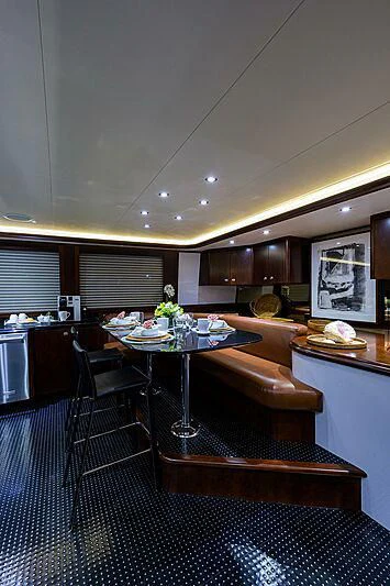 a kitchen with a table and chairs aboard UNWINED Yacht for Charter