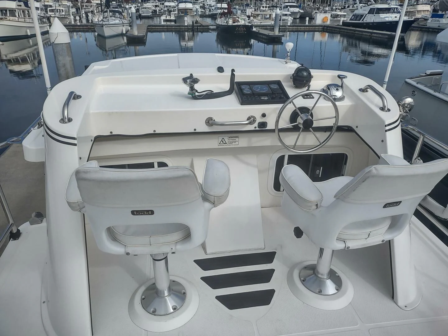 a white boat with seats aboard UNWINED Yacht for Charter