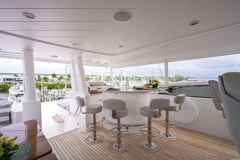 a room with tables and chairs aboard UNWINED Yacht for Charter