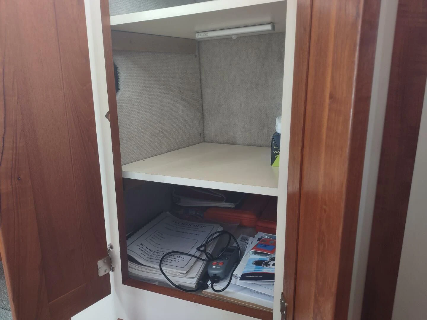 a closet with a white shelf aboard UNWINED Yacht for Charter