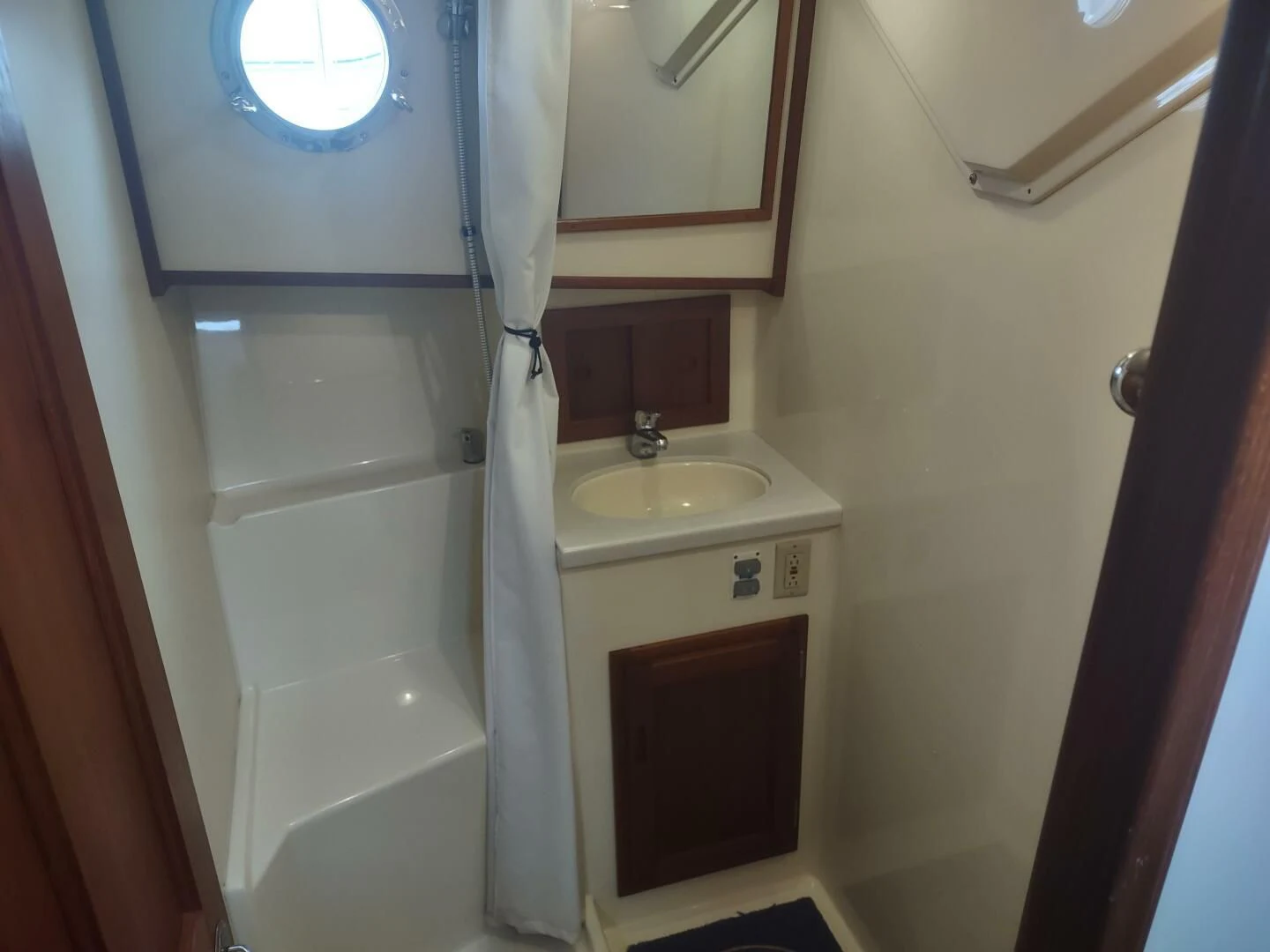 a bathroom with a sink and a mirror aboard UNWINED Yacht for Charter