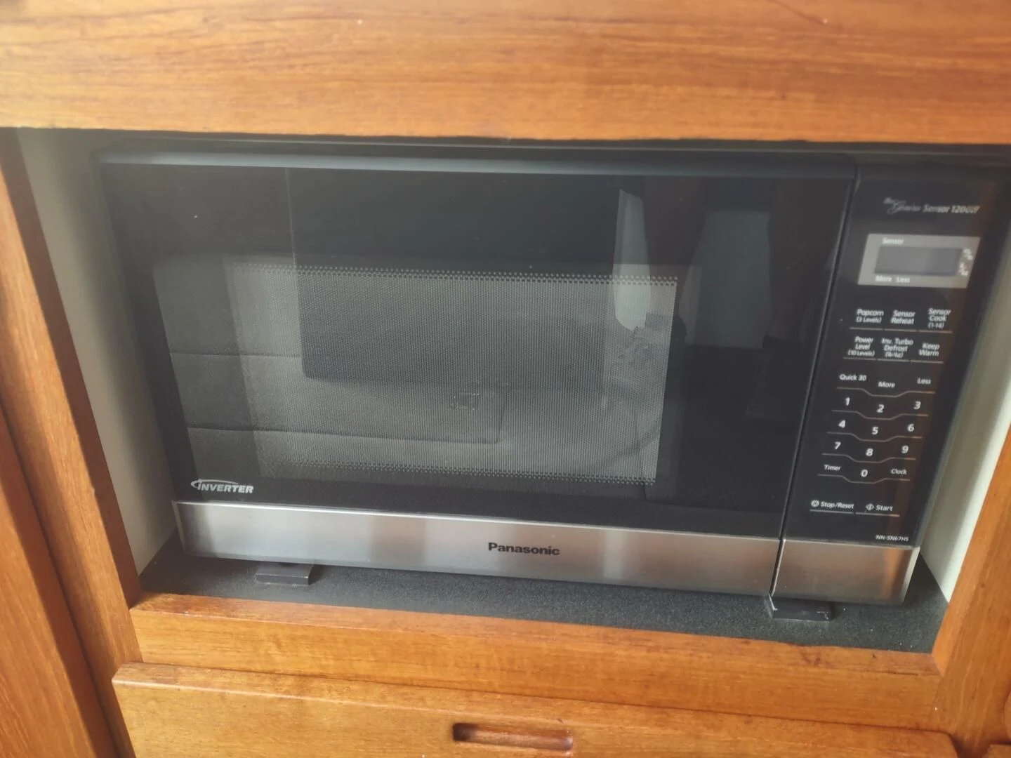 a microwave oven on a wooden surface aboard UNWINED Yacht for Charter