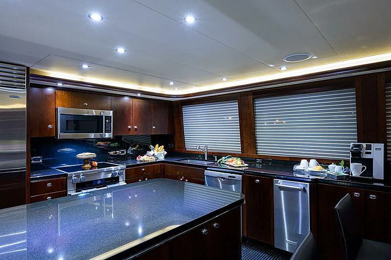 a kitchen with black cabinets aboard UNWINED Yacht for Charter