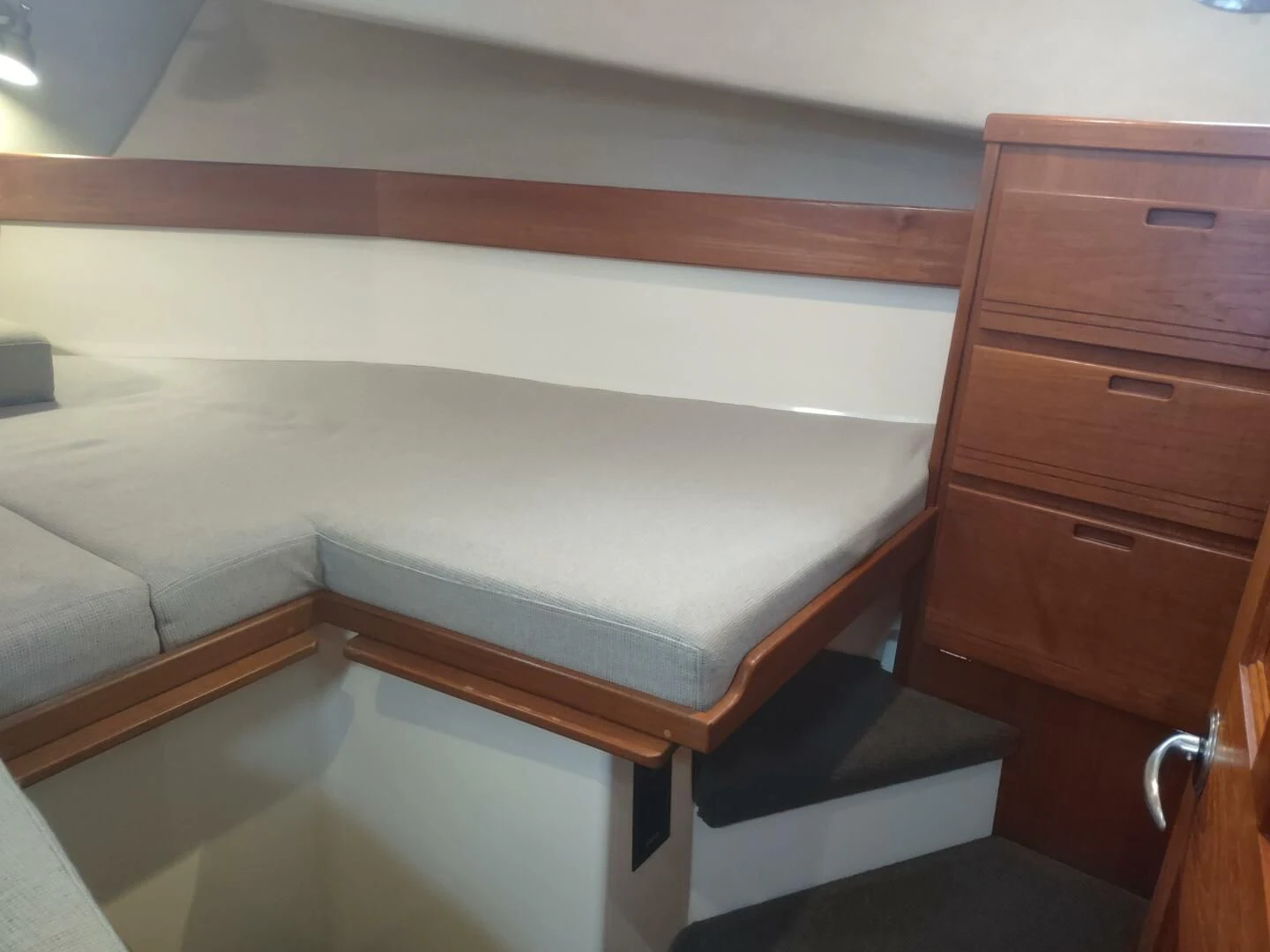 a bed with a wooden frame aboard UNWINED Yacht for Charter