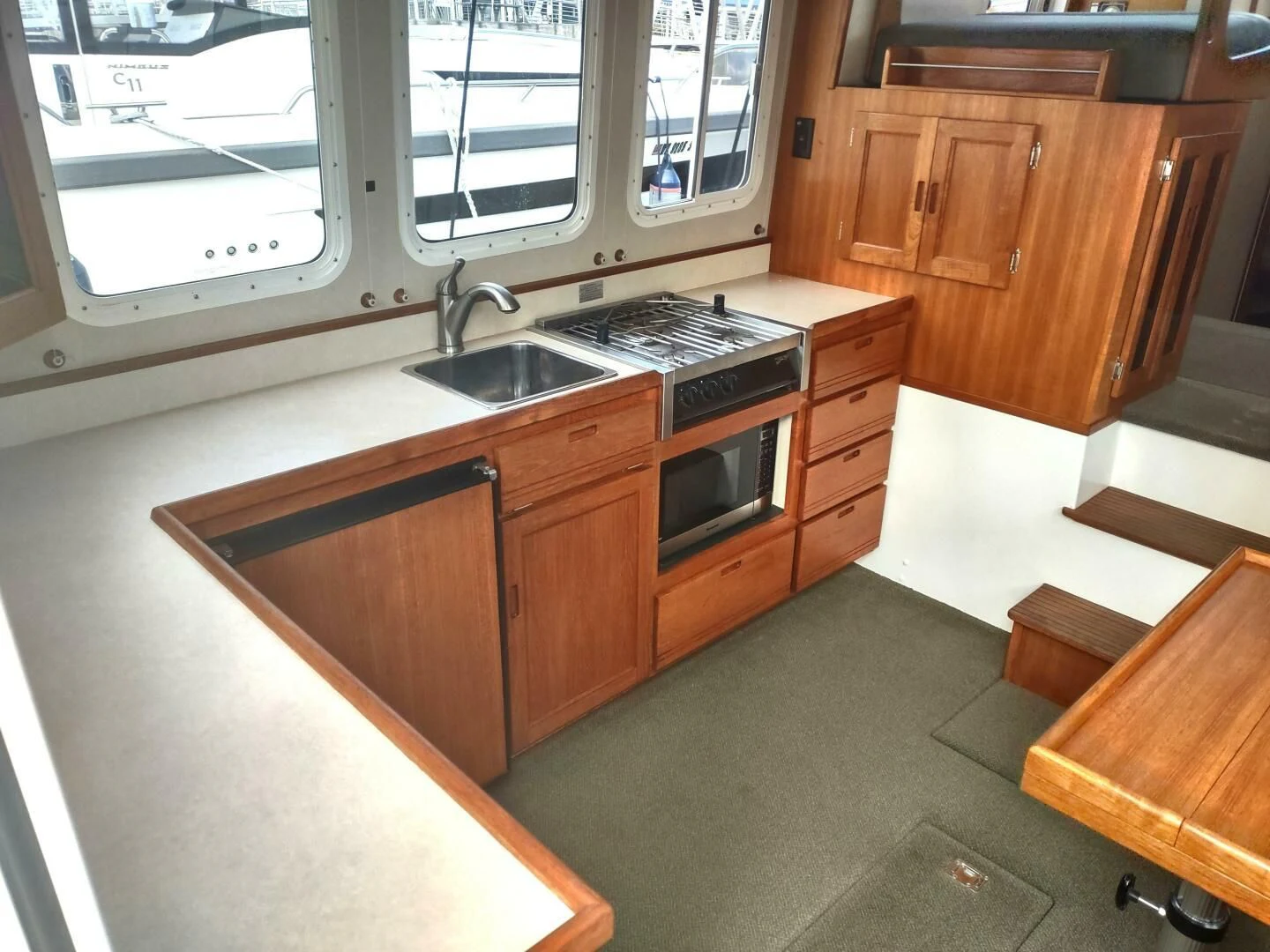 a kitchen with wooden cabinets aboard UNWINED Yacht for Charter