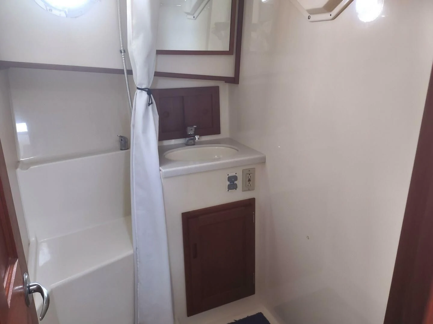 a bathroom with a sink and a mirror aboard UNWINED Yacht for Charter