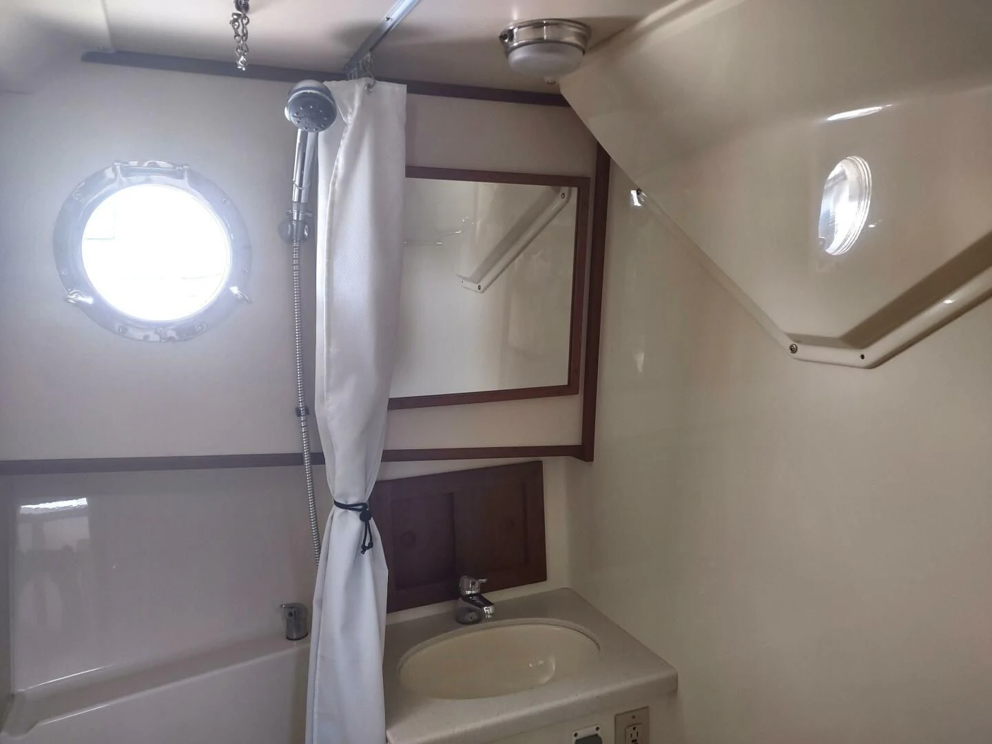 a shower curtain and sink aboard UNWINED Yacht for Charter