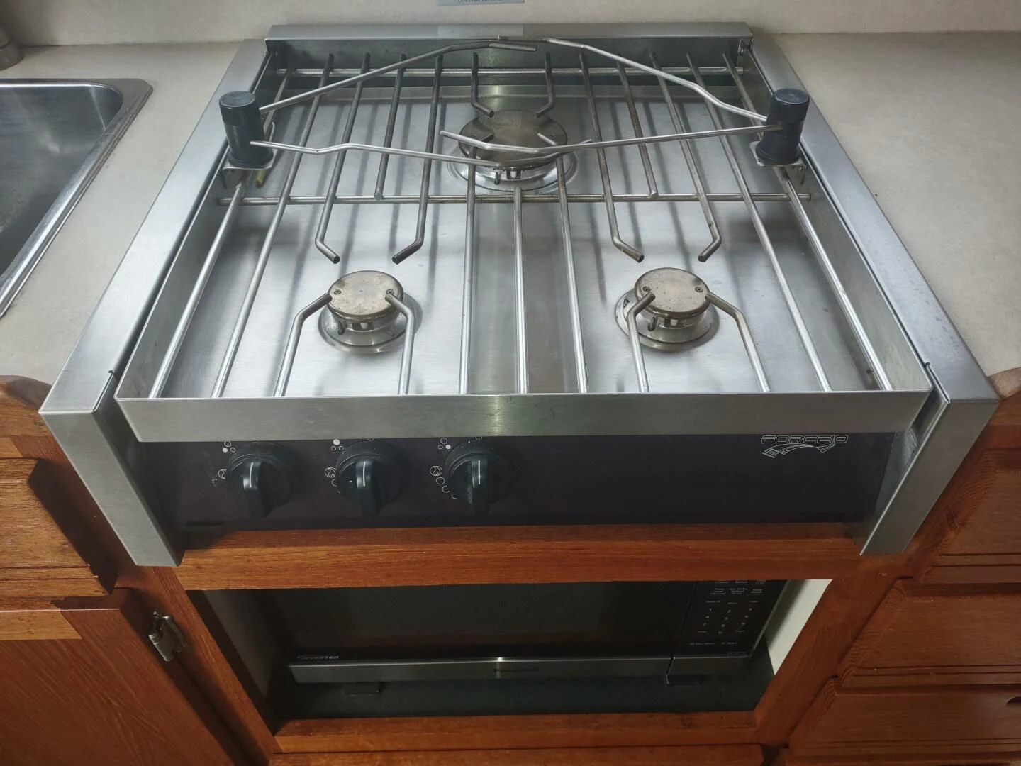 a stove top with a burner aboard UNWINED Yacht for Charter