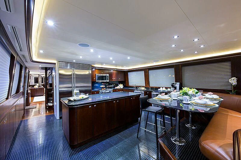 a large kitchen with a bar and dining area aboard UNWINED Yacht for Charter