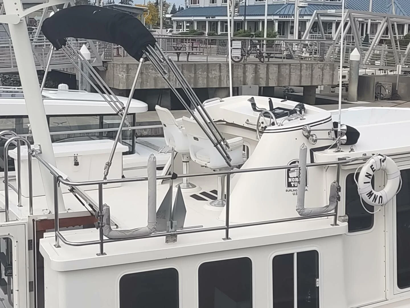 a white boat with a black and white design on it aboard UNWINED Yacht for Charter