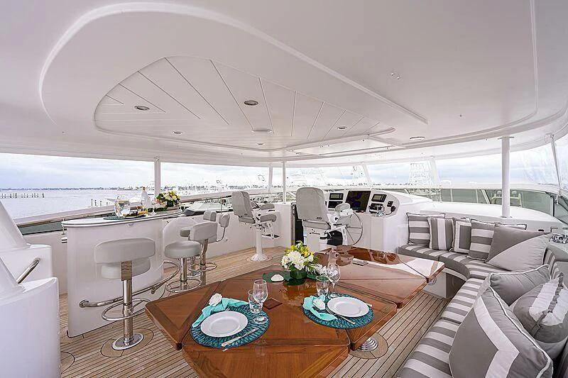 a room with a table chairs and a large window aboard UNWINED Yacht for Charter