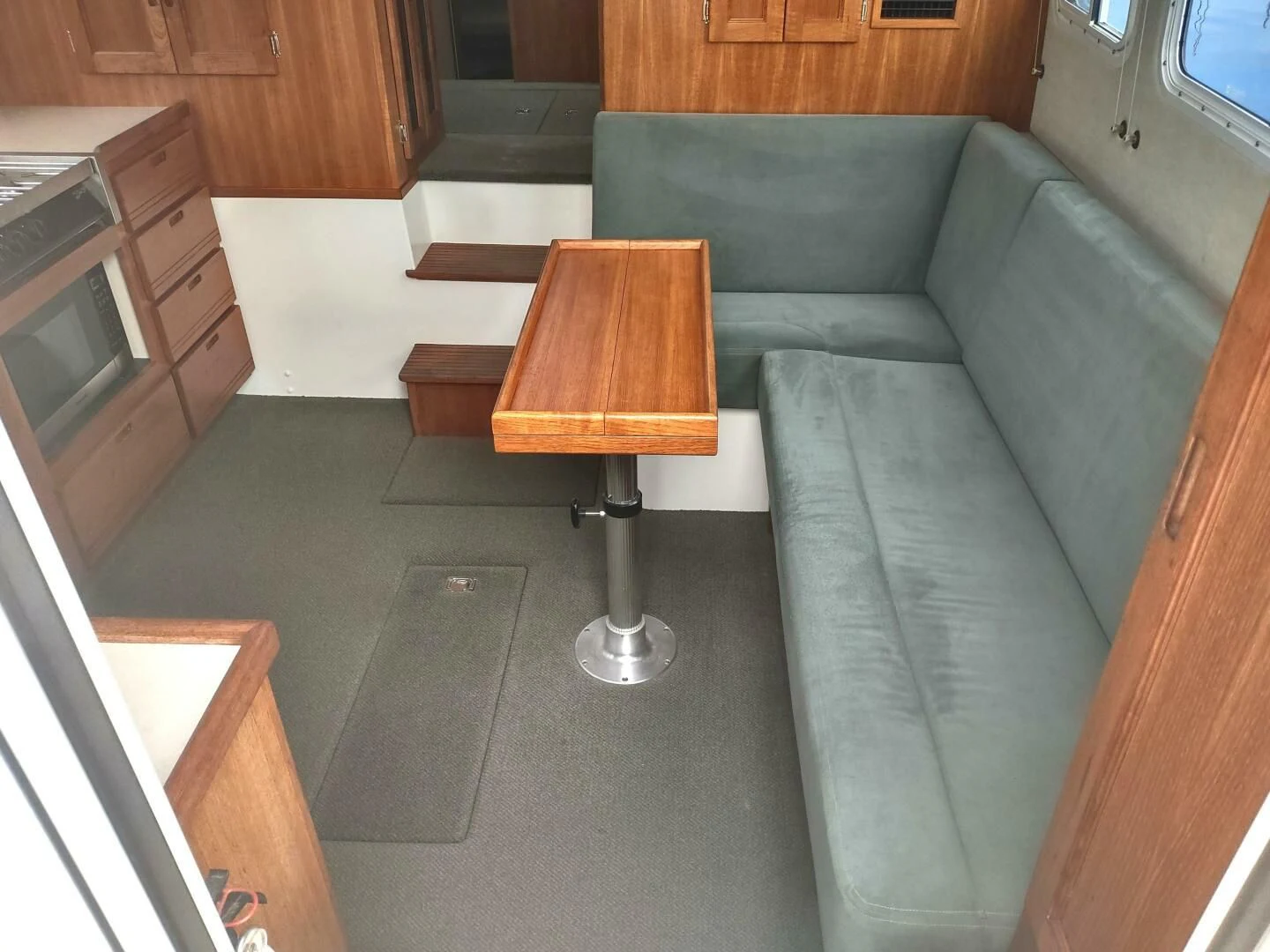 a couch and a table in a room aboard UNWINED Yacht for Charter