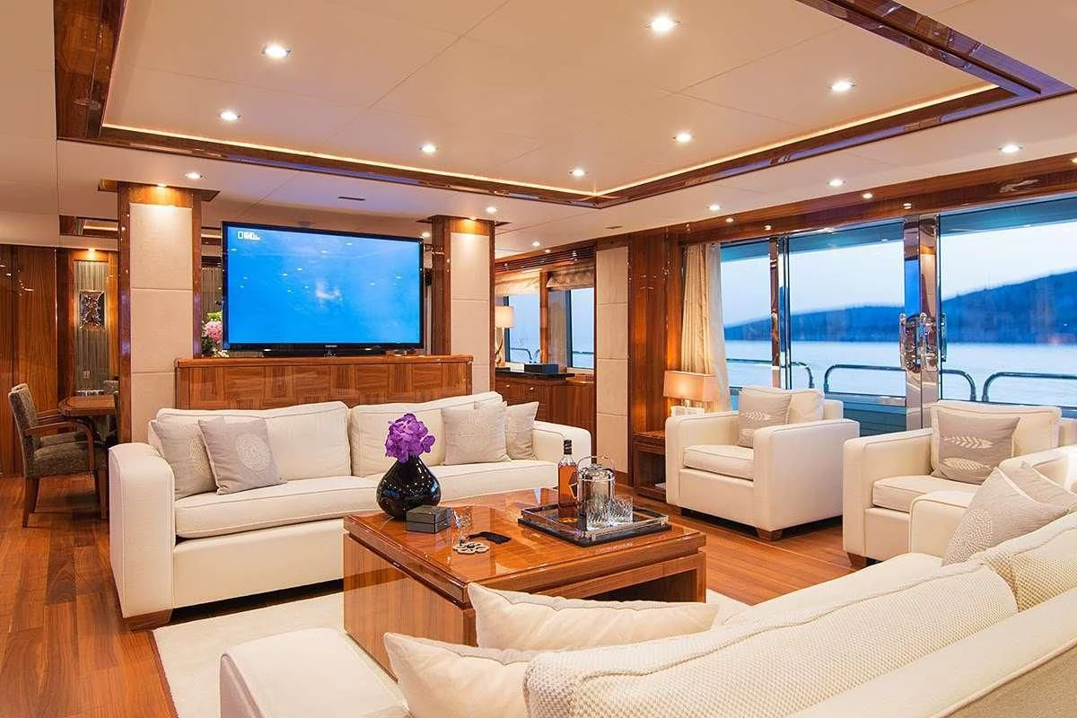 a living room with a large screen aboard PATHOS Yacht for Sale