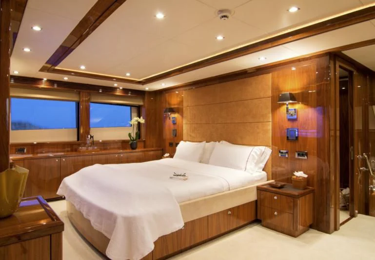 a room with a bed and a tv aboard PATHOS Yacht for Sale