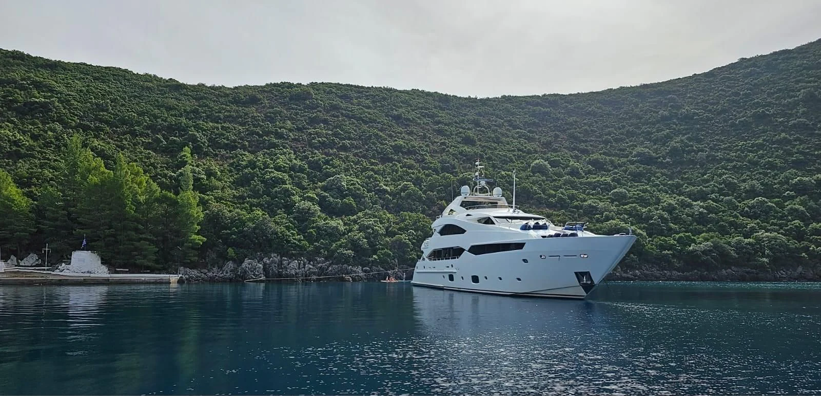 a white yacht on the water aboard PATHOS Yacht for Sale