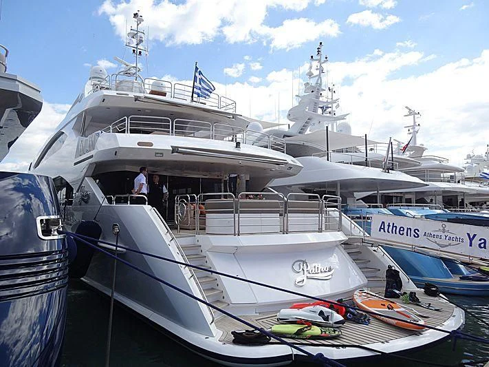 a boat docked at a pier aboard PATHOS Yacht for Sale