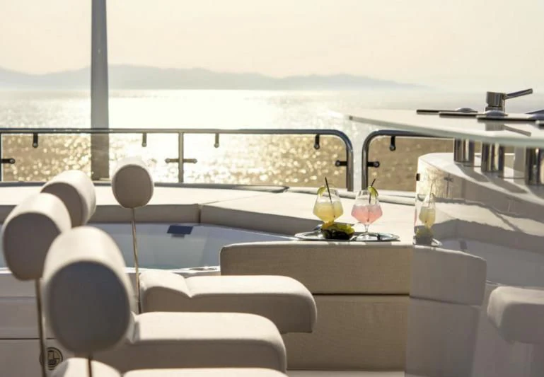 a room with a table and chairs aboard PATHOS Yacht for Sale