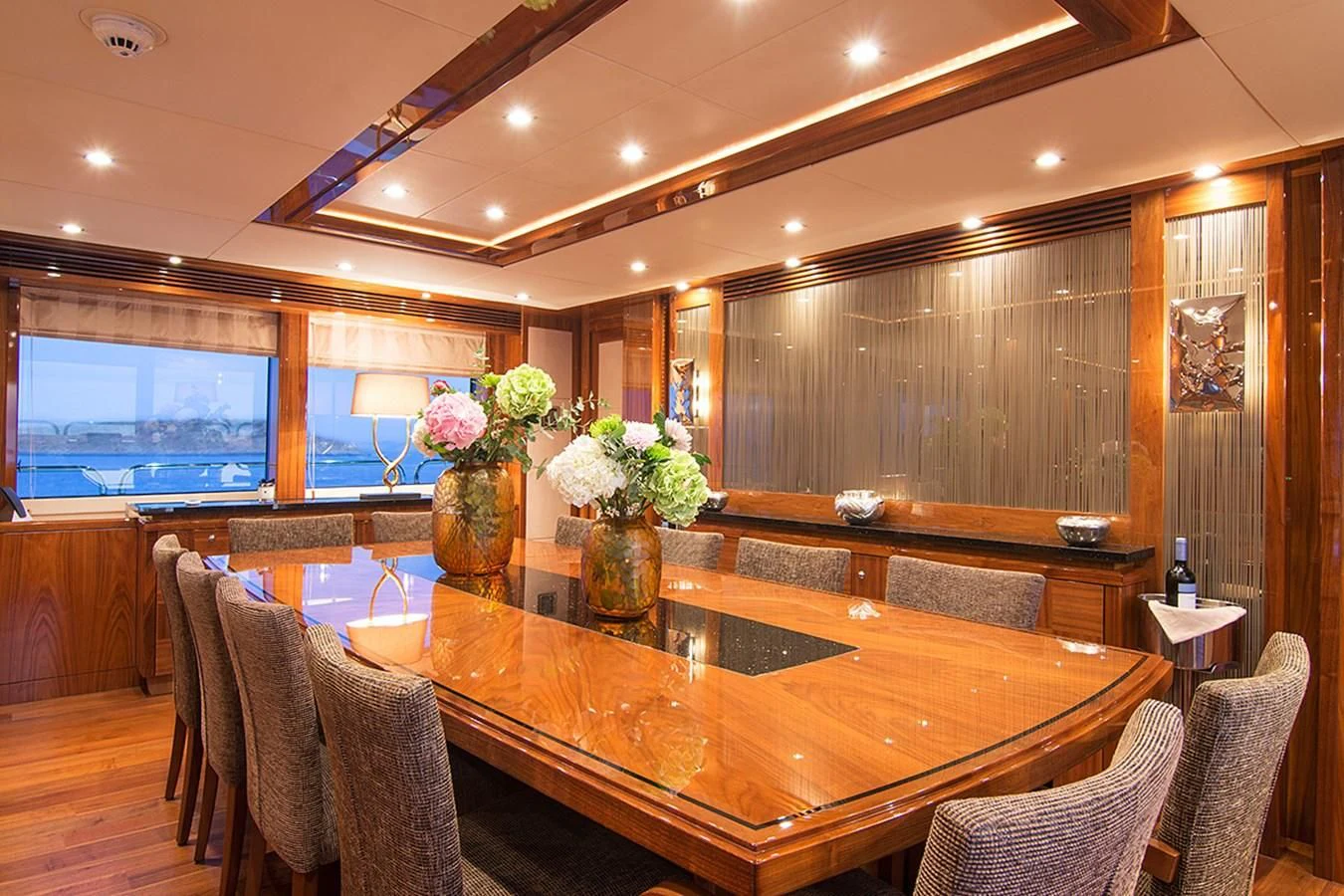 a large room with a table and chairs aboard PATHOS Yacht for Sale