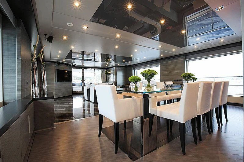 a room with a table and chairs aboard CHARISMA Yacht for Sale