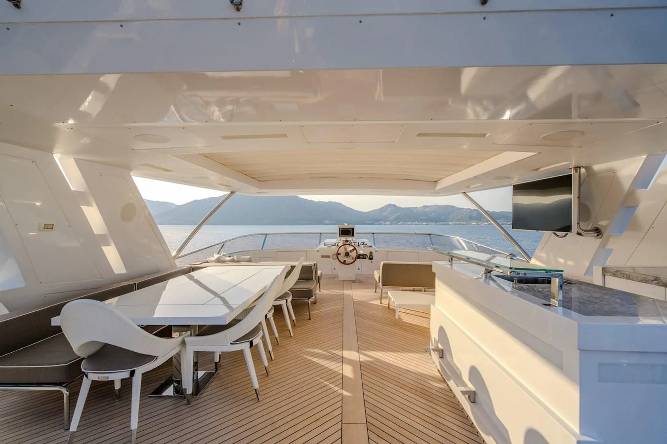 a room with tables and chairs aboard CHARISMA Yacht for Sale