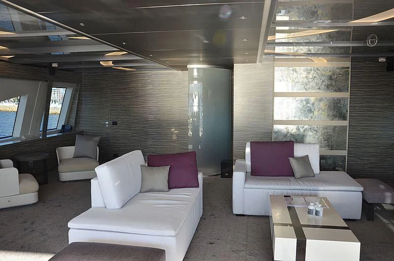 a room with a couch and a table aboard CHARISMA Yacht for Sale