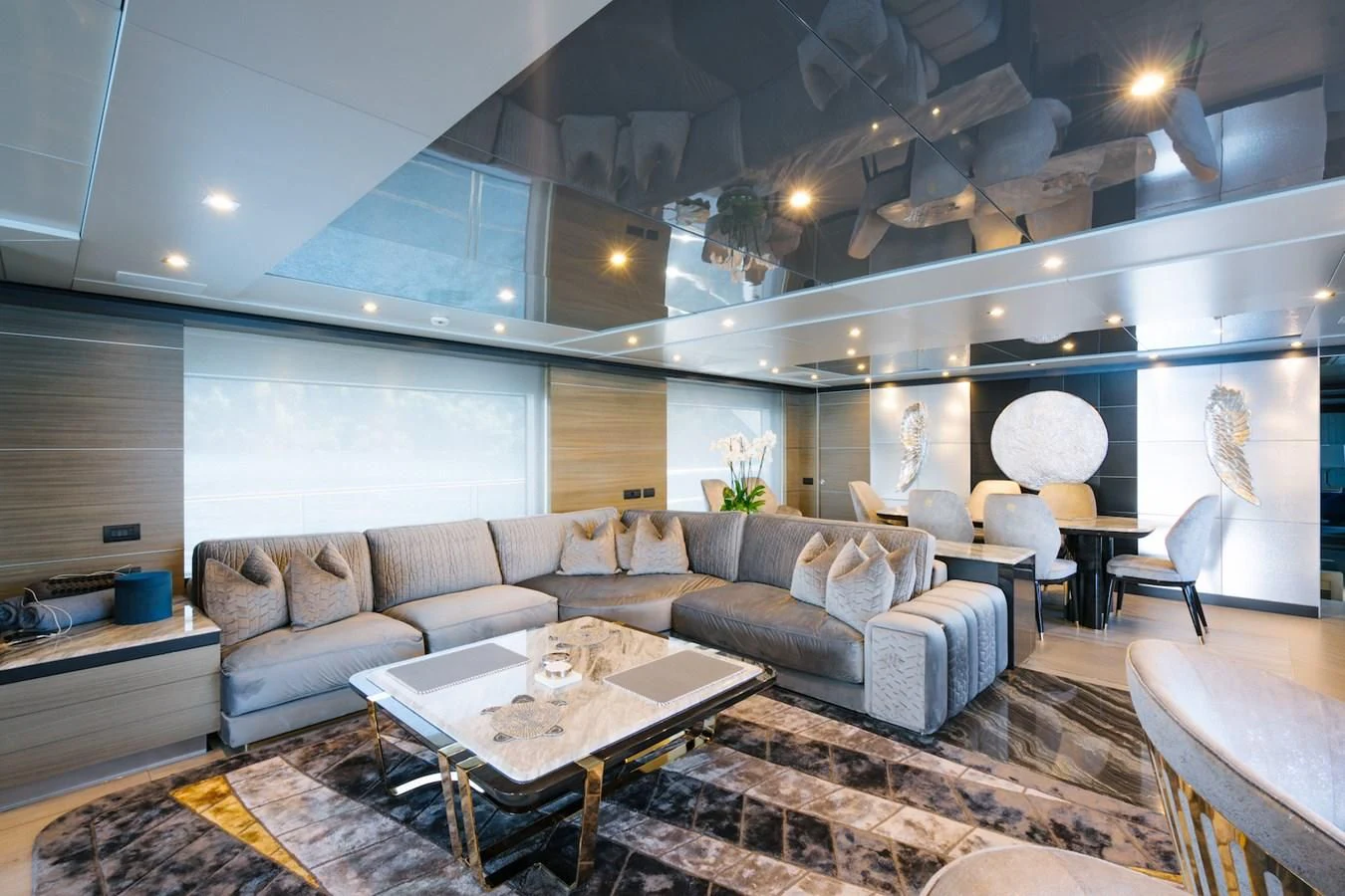 a living room with a large chandelier aboard CHARISMA Yacht for Sale