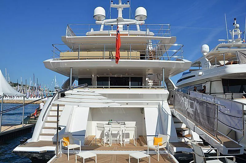 a large white boat with a red ribbon on the front aboard CHARISMA Yacht for Sale