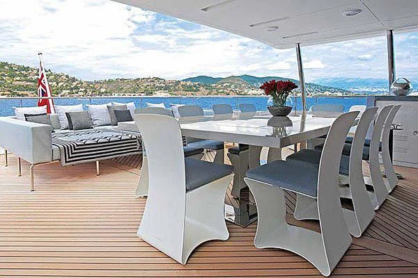 a table and chairs on a deck aboard CHARISMA Yacht for Sale