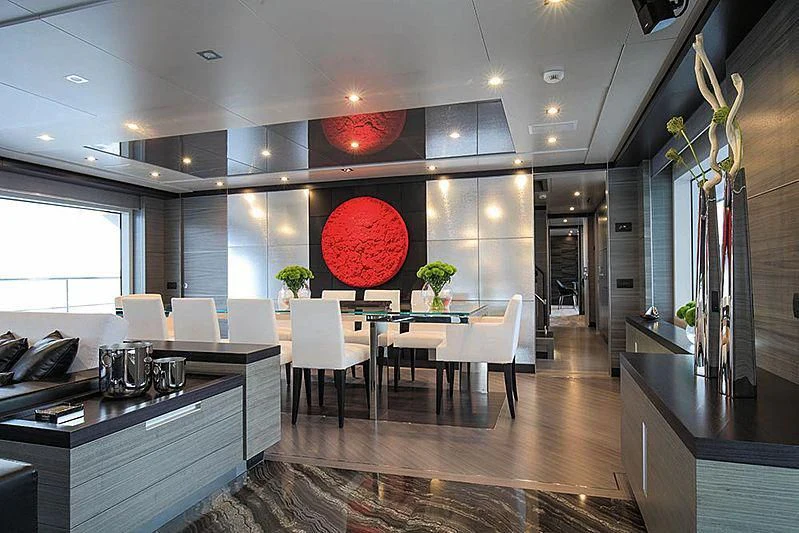 a room with a table chairs and cabinets aboard CHARISMA Yacht for Sale