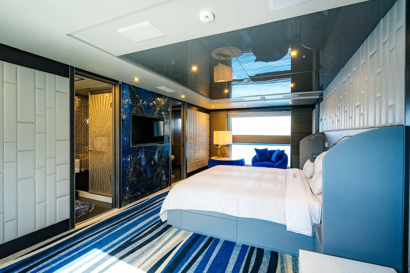 a room with a bed and a blue rug aboard CHARISMA Yacht for Sale