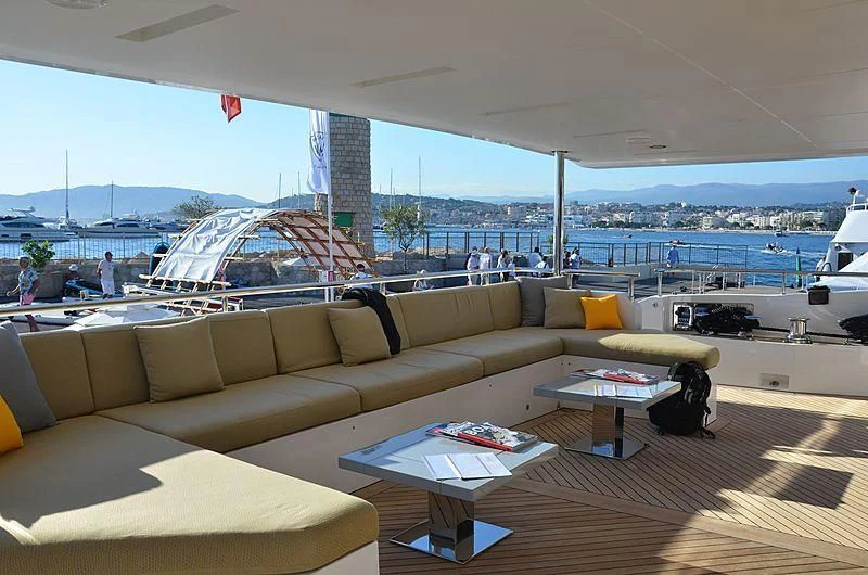 a couch and a table on a deck aboard CHARISMA Yacht for Sale