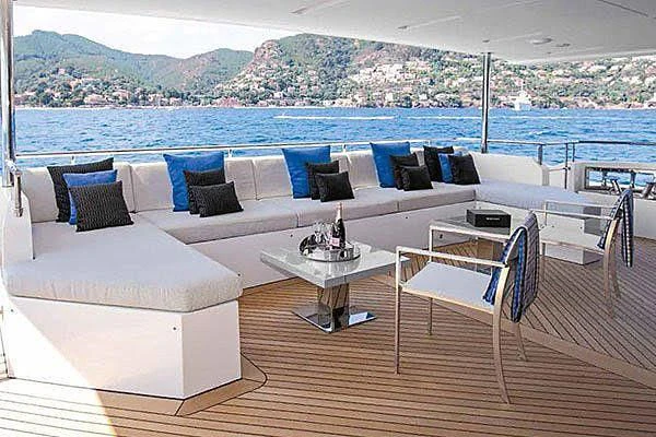 a living room with a large balcony aboard CHARISMA Yacht for Sale